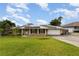 Charming home featuring solar panels, a well-manicured lawn, and a convenient two-car garage at 220 Escambia Dr, Winter Haven, FL 33884