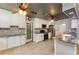 Eat-in kitchen featuring white cabinets, mosaic backsplash, and stainless-steel appliances at 220 Escambia Dr, Winter Haven, FL 33884
