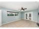 Bright living room featuring tile floors, ceiling fan, and french doors leading to the lanai at 220 Escambia Dr, Winter Haven, FL 33884