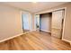 Bedroom with wood-look floors and mirrored closet doors at 2201 Flamingo Ave, Deltona, FL 32738
