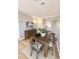 Bright dining room with stylish table, seating for four, modern art and wood floors at 2201 Flamingo Ave, Deltona, FL 32738