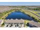Beautiful aerial view of townhomes, a scenic pond, and lush greenery in a tranquil setting at 9971 Highland Sky Aly, Orlando, FL 32832