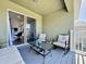 Cozy outdoor balcony with stylish furniture overlooking neighborhood at 9971 Highland Sky Aly, Orlando, FL 32832