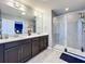 Bathroom with double sink vanity and glass-enclosed shower, perfect for a modern lifestyle at 9971 Highland Sky Aly, Orlando, FL 32832
