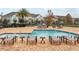 Inviting community pool area with ample lounge chairs for residents to enjoy the sun at 9971 Highland Sky Aly, Orlando, FL 32832
