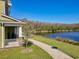 Exterior view of the property with a walking path along the waterfront at 9971 Highland Sky Aly, Orlando, FL 32832
