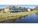 Townhome community next to a serene pond with lush landscaping at 9971 Highland Sky Aly, Orlando, FL 32832