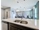 A bright modern kitchen featuring an island with a double sink that overlooks the dining and living rooms at 9971 Highland Sky Aly, Orlando, FL 32832
