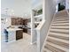 Contemporary kitchen with stainless steel appliances and center island; stairs located nearby at 9971 Highland Sky Aly, Orlando, FL 32832
