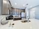 Modern kitchen features stainless appliances and a beautiful island countertop with a double sink at 9971 Highland Sky Aly, Orlando, FL 32832