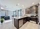 Bright kitchen with stainless steel appliances and an island that overlooks an open living area at 9971 Highland Sky Aly, Orlando, FL 32832