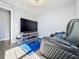 Living room area with recliner, entertainment system, and blue rug at 9971 Highland Sky Aly, Orlando, FL 32832