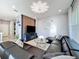 Inviting living room featuring a modern lighting fixture and a large, comfortable sectional sofa at 9971 Highland Sky Aly, Orlando, FL 32832