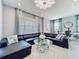 Bright and airy living room with stylish decor, large windows, and a comfortable sectional sofa at 9971 Highland Sky Aly, Orlando, FL 32832