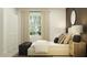 Chic bedroom with natural light, stylish decor, and a minimalist aesthetic at 1169 Hour Glass Rd, Lakeland, FL 33801