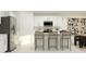 Bright kitchen features white cabinets, stainless steel appliances, and a stylish island with seating at 1169 Hour Glass Rd, Lakeland, FL 33801