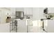 Modern kitchen showcasing white cabinetry, stainless steel appliances, and an island with comfortable bar stools at 1169 Hour Glass Rd, Lakeland, FL 33801