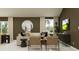 Elegant living room featuring a comfortable sofa, stylish chairs, and a decorative mirror at 1169 Hour Glass Rd, Lakeland, FL 33801