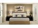 Serene bedroom with a comfortable bed, stylish lamps, and a large abstract painting at 1169 Hour Glass Rd, Lakeland, FL 33801