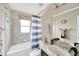 Cozy bathroom with neutral tones, a shower-tub combo, and ample natural light at 305 St Georges Cir, Eagle Lake, FL 33839