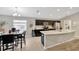 Inviting dining area with a modern table set, dark wood cabinets, and lots of natural light at 305 St Georges Cir, Eagle Lake, FL 33839