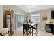 Bright dining room with a sliding glass door to the lanai, creating a relaxed atmosphere at 305 St Georges Cir, Eagle Lake, FL 33839