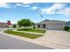Corner lot featuring a gray home with an attached two-car garage and pristine landscaping at 305 St Georges Cir, Eagle Lake, FL 33839