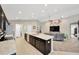 Spacious kitchen with an island, stainless steel appliances, and seamlessly connected to the living area at 305 St Georges Cir, Eagle Lake, FL 33839