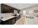 Well-lit kitchen featuring stainless steel appliances, marble countertops, and dark wood cabinetry at 305 St Georges Cir, Eagle Lake, FL 33839