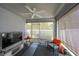 Cozy lanai area with ample seating, perfect for relaxation and enjoying the outdoor view at 305 St Georges Cir, Eagle Lake, FL 33839