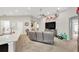 Open-concept living room with an entertainment system, stylish decor, and a comfortable seating area at 305 St Georges Cir, Eagle Lake, FL 33839