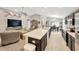 Bright, open-concept kitchen and living room, complete with an island and dining area at 305 St Georges Cir, Eagle Lake, FL 33839