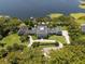 Stunning aerial view of a grand estate with meticulously manicured grounds and private lake access at 5500 W Lake Butler Rd, Windermere, FL 34786
