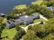 Stunning lakeside home boasts lush landscaping, a private dock, and an inviting backyard pool at 5500 W Lake Butler Rd, Windermere, FL 34786