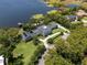 Magnificent aerial shot showcasing a sprawling property with lush landscaping, a lake, and private dock at 5500 W Lake Butler Rd, Windermere, FL 34786