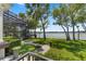 Beautiful backyard with screened enclosure, lush landscaping, and stunning lake views, perfect for outdoor living at 5500 W Lake Butler Rd, Windermere, FL 34786