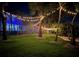 Beautifully lit backyard with string lights, lush greenery, and an inviting poolside area at 5500 W Lake Butler Rd, Windermere, FL 34786