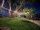 Picturesque backyard featuring a swing bed and beautiful string lights illuminating the landscape at 5500 W Lake Butler Rd, Windermere, FL 34786
