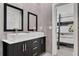 Modern bathroom with dual sinks, sleek gray tiling, and view into bedroom at 5500 W Lake Butler Rd, Windermere, FL 34786