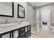 Modern bathroom featuring double sink vanity, glass-enclosed shower, and neutral tile flooring for a sleek and contemporary design at 5500 W Lake Butler Rd, Windermere, FL 34786