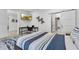 Comfortable bedroom with study area, mounted TV, and view into bathroom at 5500 W Lake Butler Rd, Windermere, FL 34786