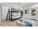 Bright bedroom featuring a bunk bed, modern art, and an inviting, stylish rug at 5500 W Lake Butler Rd, Windermere, FL 34786