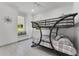 Bright bedroom with a metal bunk bed, window seat and view at 5500 W Lake Butler Rd, Windermere, FL 34786