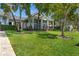 A stately home with a beautiful lawn is surrounded by mature trees at 5500 W Lake Butler Rd, Windermere, FL 34786