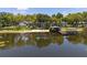 Tranquil lakefront property with a sandy beach, boat dock, and beautifully landscaped grounds at 5500 W Lake Butler Rd, Windermere, FL 34786