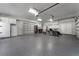 Spacious garage with epoxy flooring, built-in cabinets and shelving, and room for vehicles and storage at 5500 W Lake Butler Rd, Windermere, FL 34786