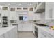Modern kitchen with quartz countertops, stainless steel appliances, and custom cabinetry at 5500 W Lake Butler Rd, Windermere, FL 34786