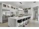 Beautiful white kitchen featuring stainless appliances, waterfall island with seating, and custom cabinets at 5500 W Lake Butler Rd, Windermere, FL 34786