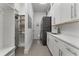 Functional laundry room with modern washer and dryer, sink, and ample storage space at 5500 W Lake Butler Rd, Windermere, FL 34786