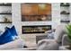 Stylish living room featuring a modern fireplace and floating shelves at 5500 W Lake Butler Rd, Windermere, FL 34786